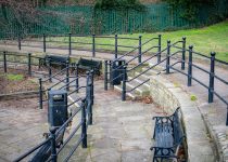 stacked stone and metal fencing